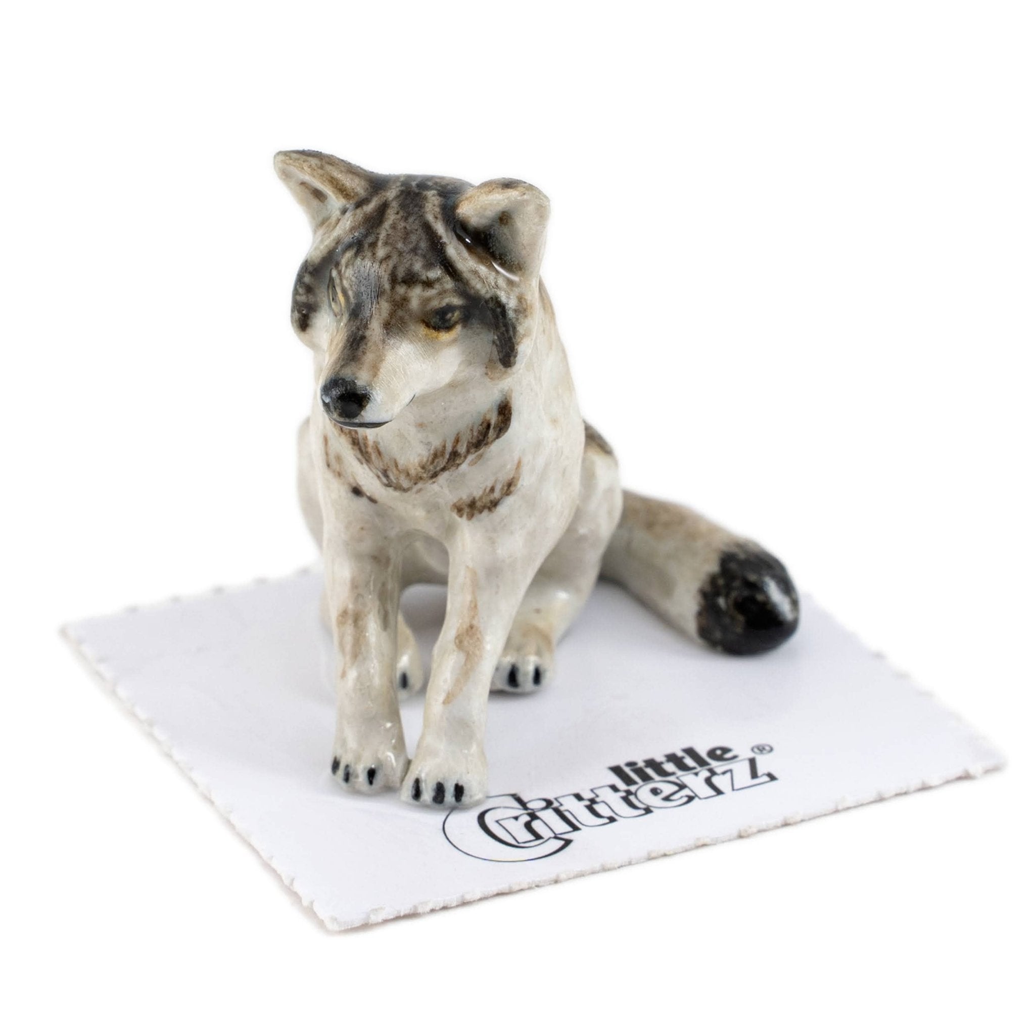 Akela Wolf Sitting Porcelain Miniature - Spiral Circle