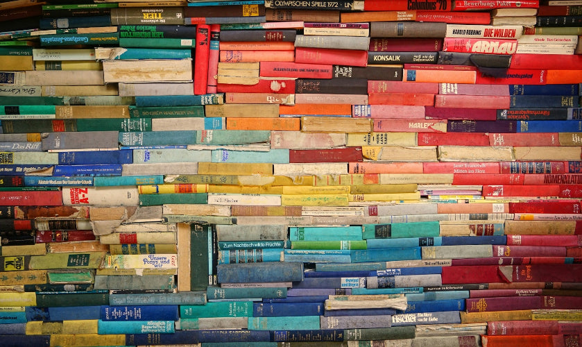 Wall made of stacked books in various colors